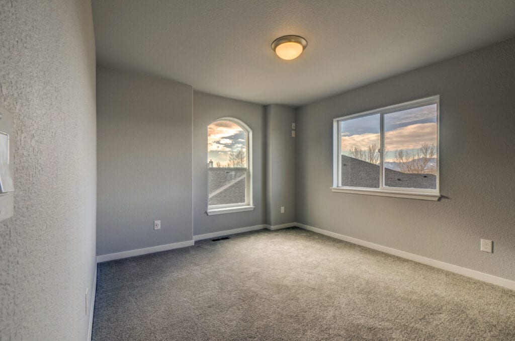 Basement Bedroom with grey walls and brown carpet
